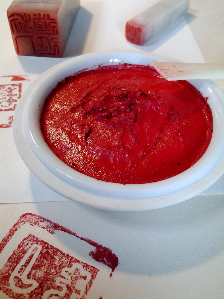The cinnabar (or vermillion) paste with the ox bone smoothing spatula.