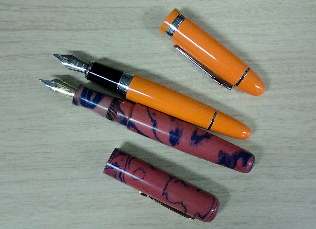 Both pens uncapped. The Moody has a better section and is much more comfortable to use.
